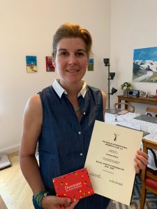 Caroline with her award and gift vouchers